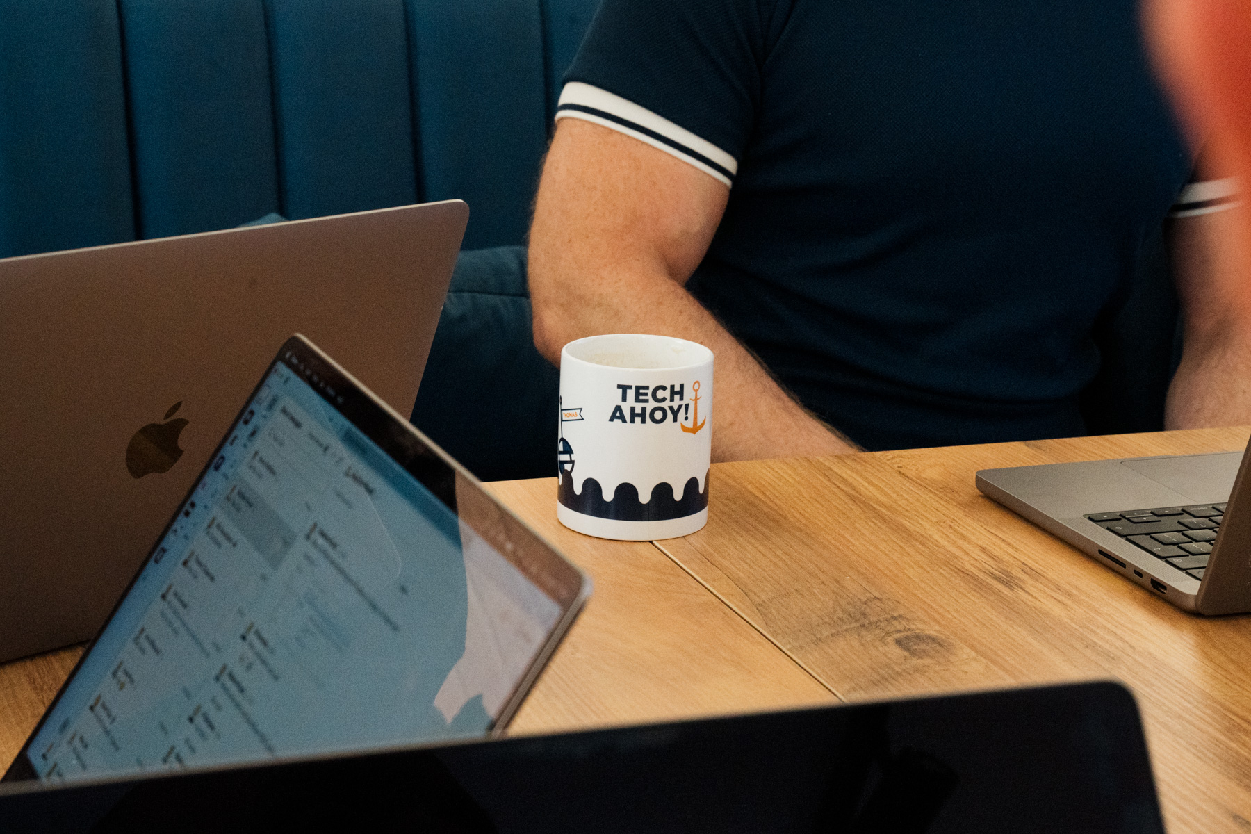 branded mug and laptops on desk